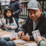 Group playing cards outdoors, face cards visible on the table